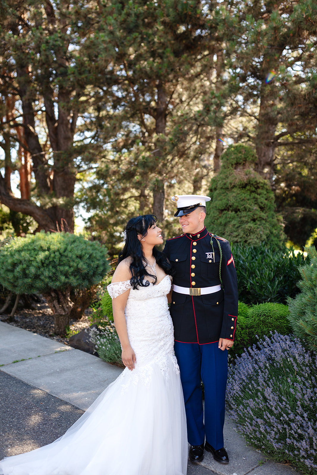 Newlyweds sharing a quiet portrait beneath the evergreens at Stone Ridge Estates
