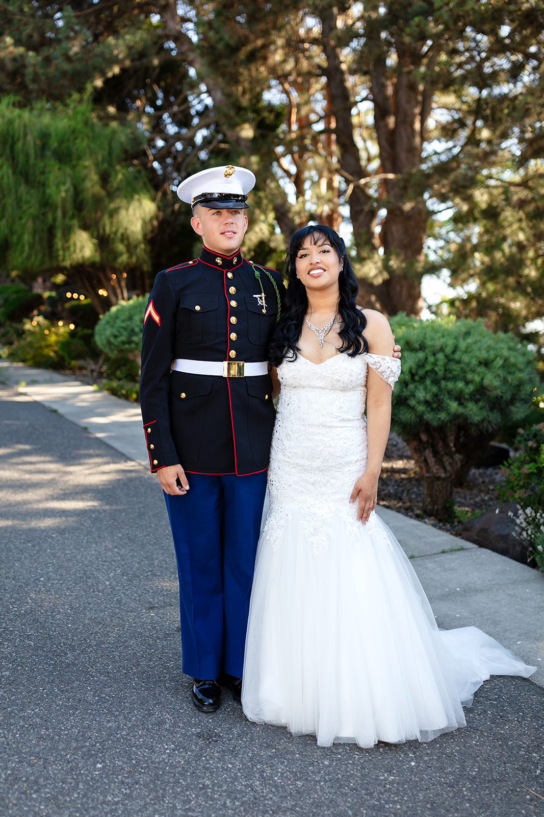 A newly married couple beneath the evergreens at Stone Ridge Estates