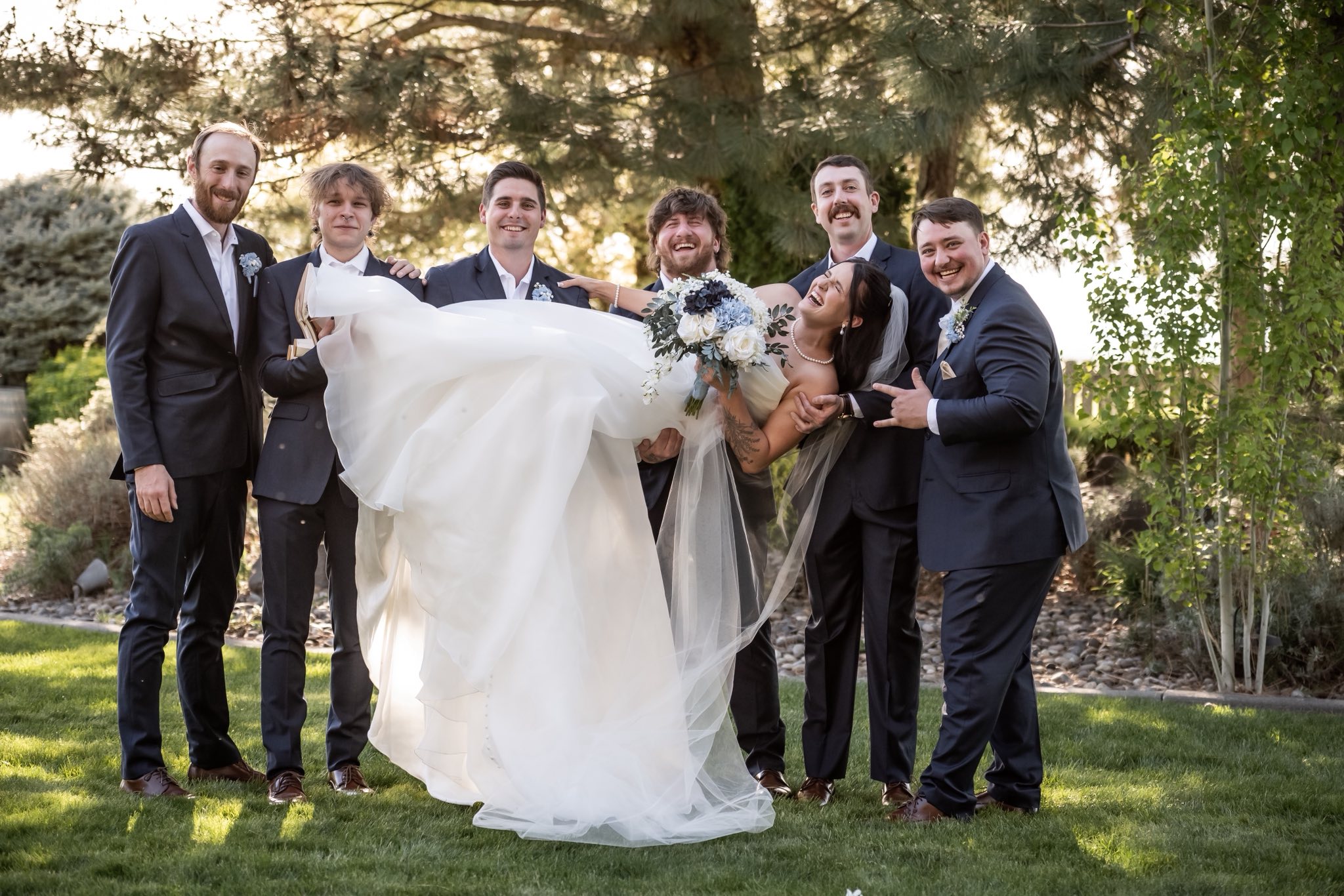 A joyful bride and wedding party portrait at Stone Ridge Estates