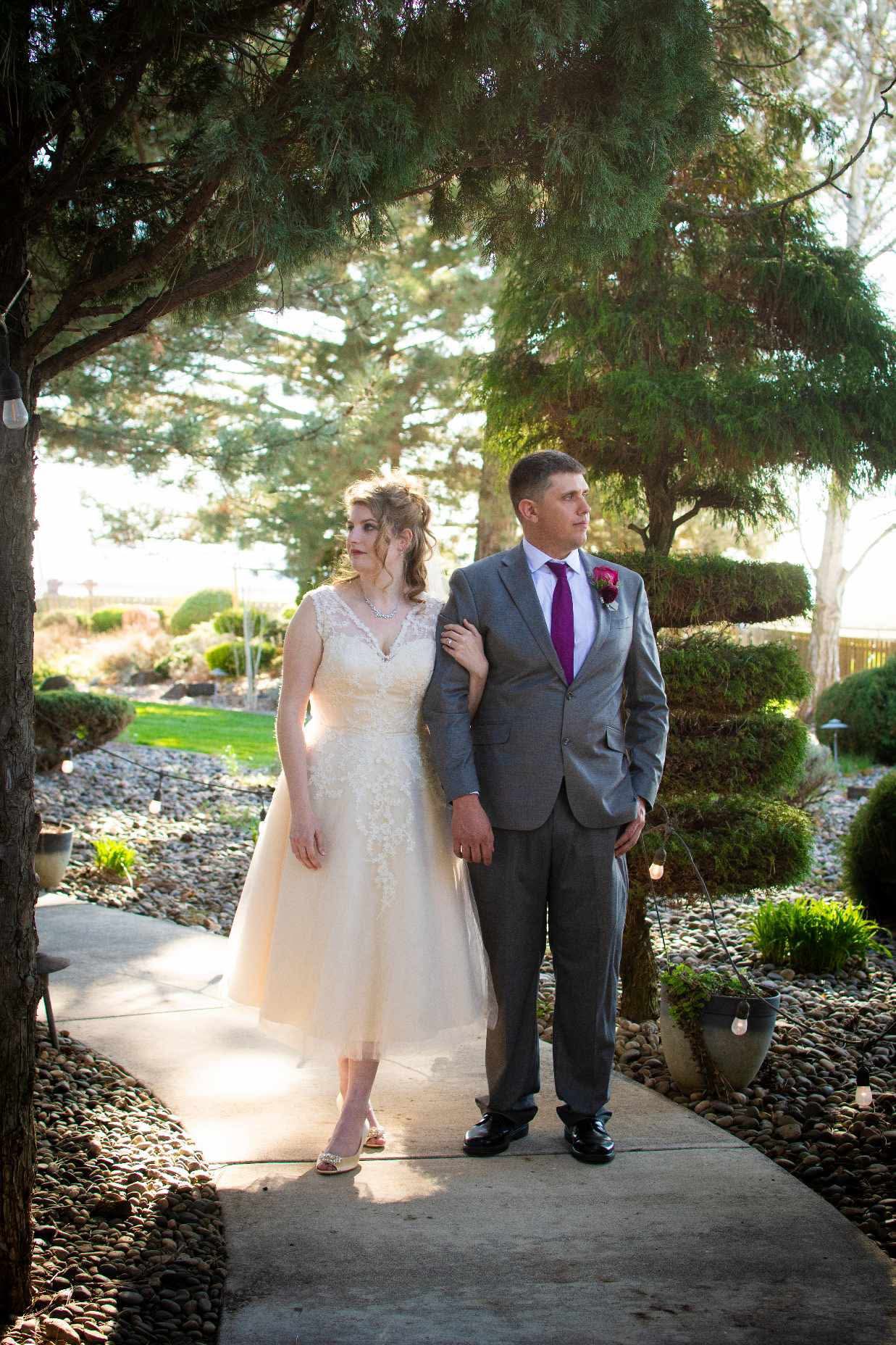 A spring wedding portrait beneath the evergreens at Stone Ridge Estates