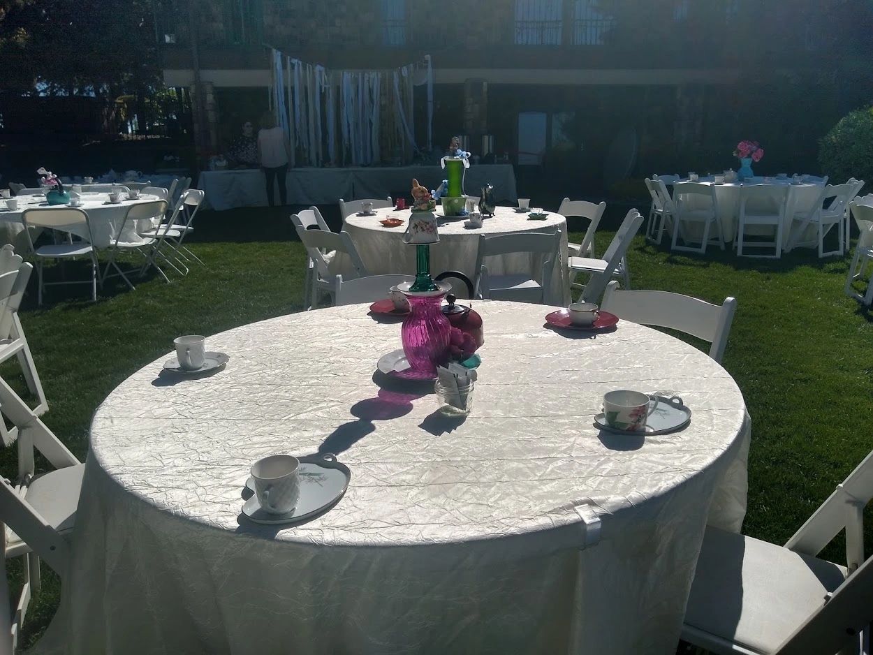 Colorful teacups and saucers arranged for the Stone Ridge Tea Party